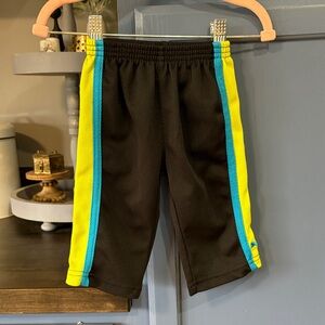 Puma Kids Black Pants with Vibrant Yellow and Blue Accents